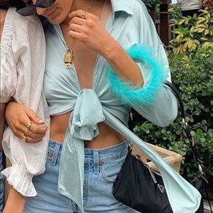 aqua/blue shirt w/ feathers